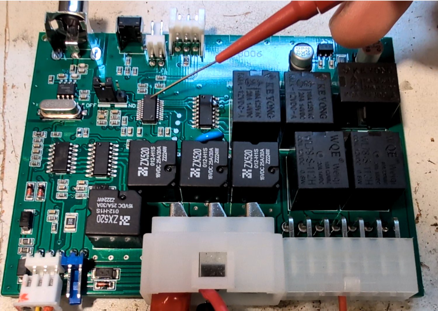 Probing the actuation side of the board -- door lock, trunk, indicator, and horn relay outputs -- with an oscilloscope.
