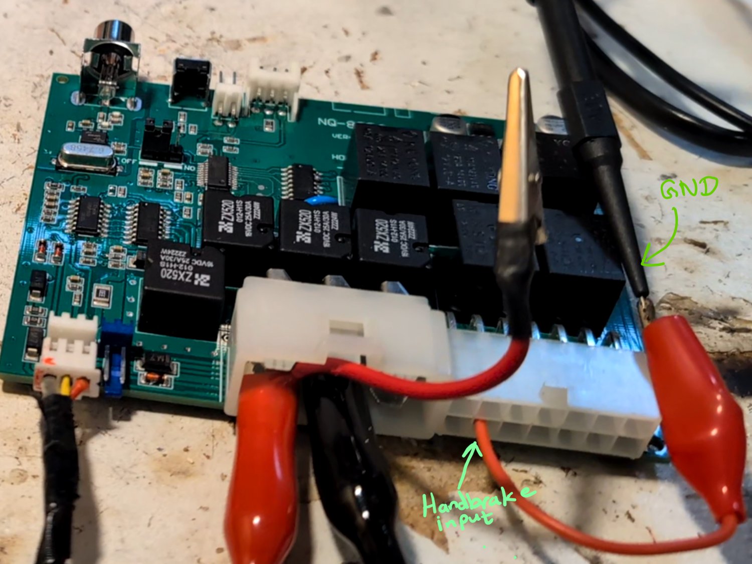 Manually grounding the handbrake input pin to simulate the handbrake being engaged.