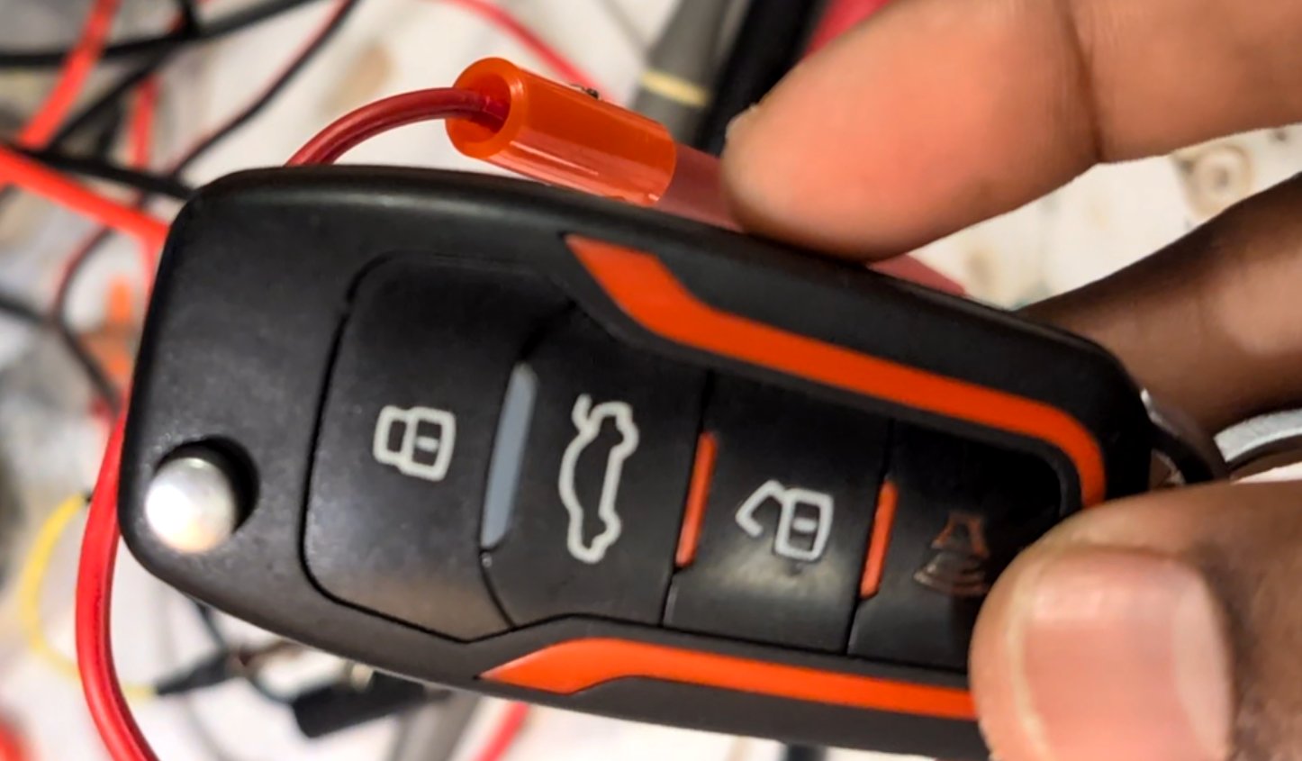 Opening up the remote key fob to access its internal circuit board.