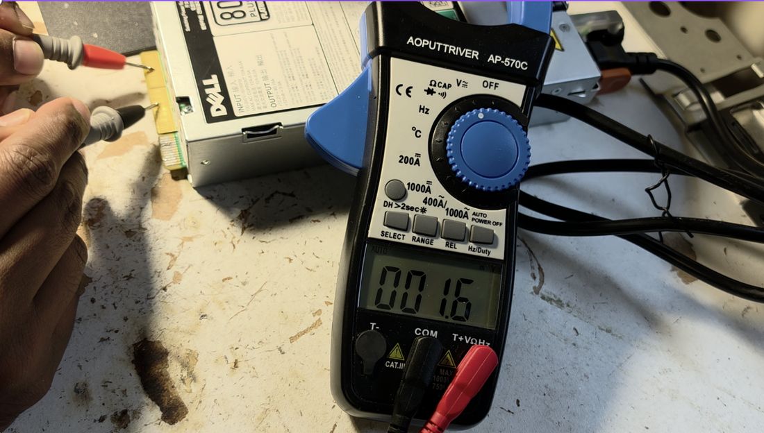 Main output terminals reading ~1.8 mV with only mains power applied &mdash; the main rail isn't enabled yet.