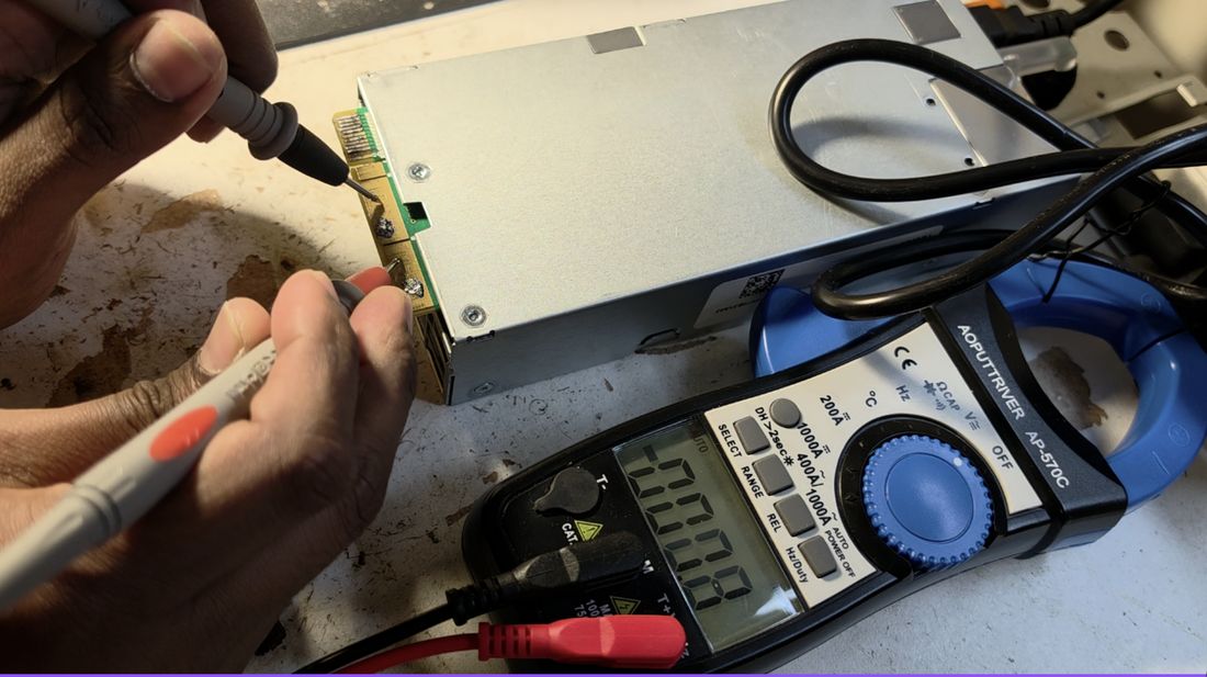 Flip side: the edge terminal is main +12 V, the center terminal is ground, reading 0 V for now.