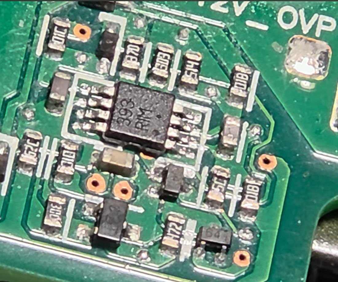 LM393 over-voltage-protection comparator, next to the unidentified “64”-marked component.