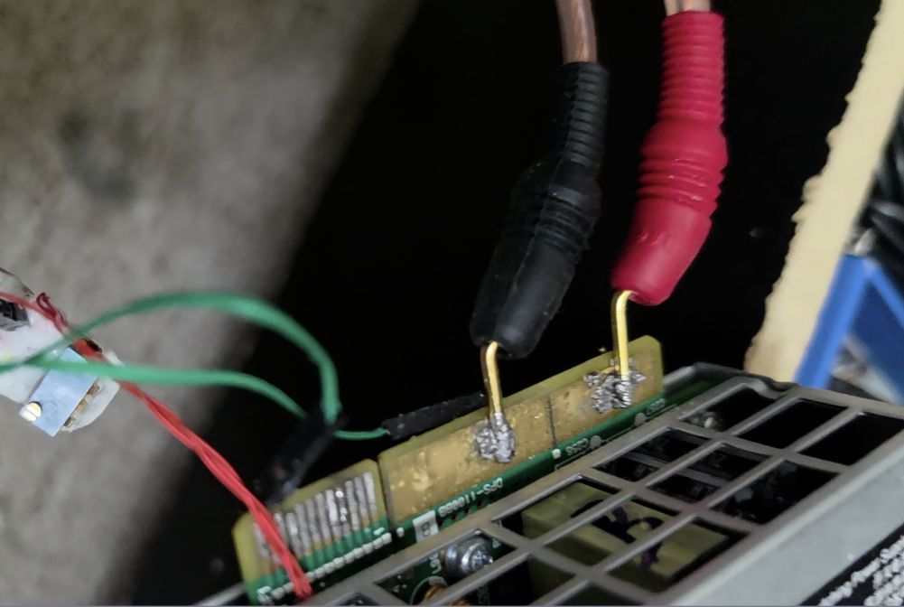 Reassembled supply with heavy-gauge output leads for load testing.