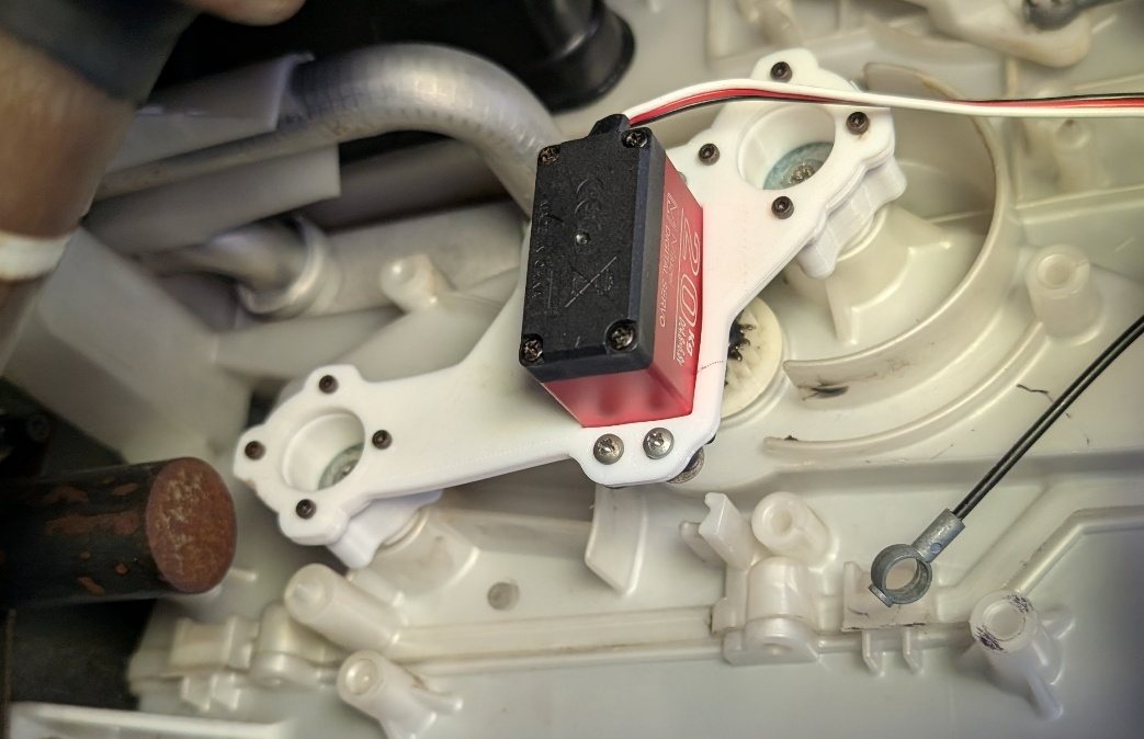 The printed two-anchor servo bracket installed on the AC actuator in the car.