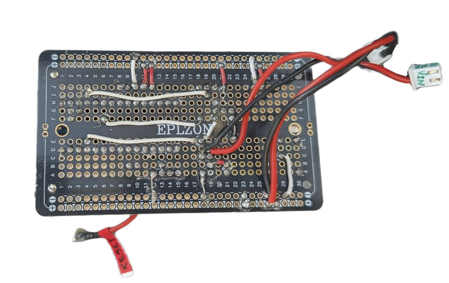 The rear side of the custom PCB, showing hand-soldered connections.