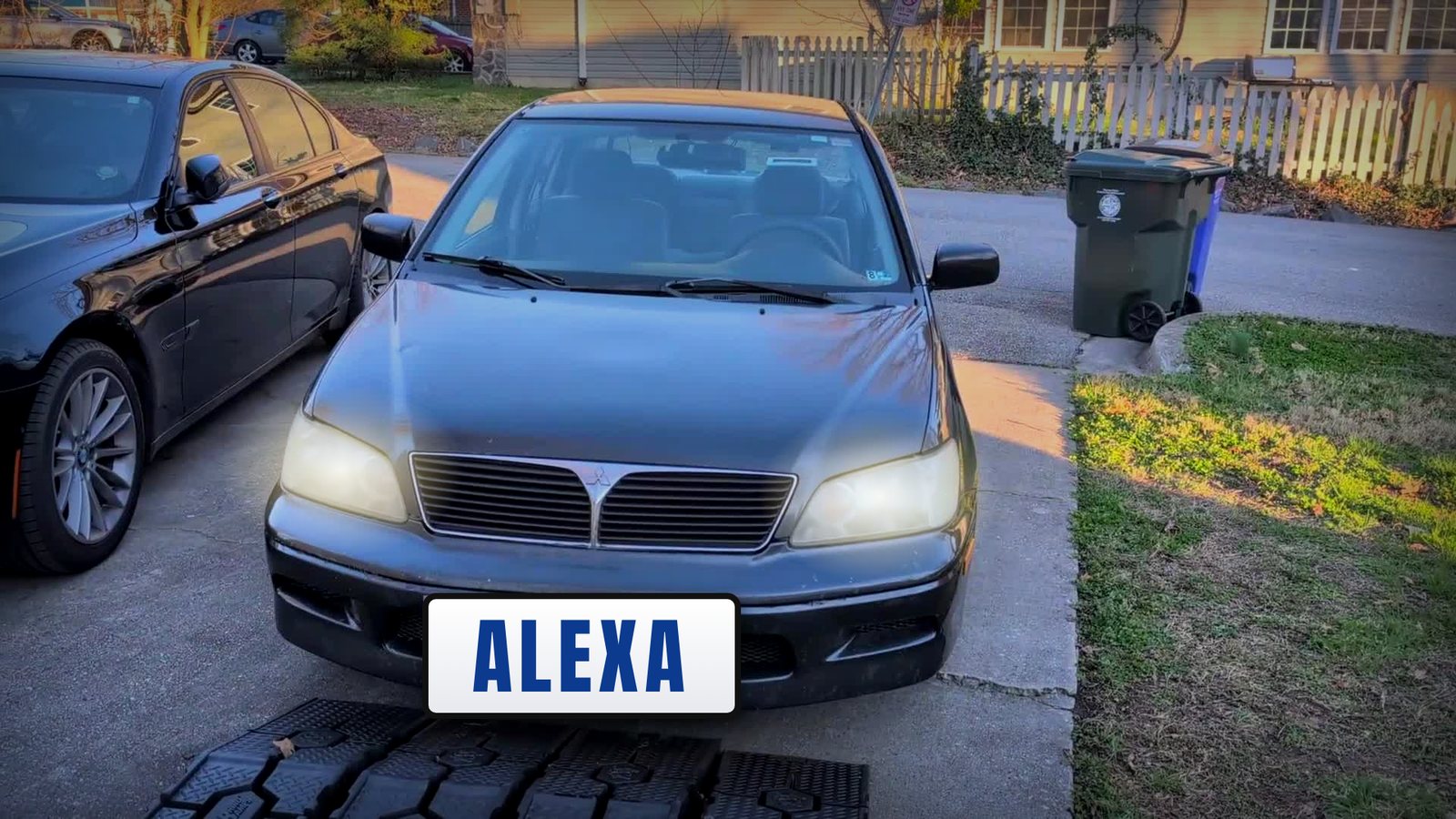 The 2003 Mitsubishi Lancer with its headlights on and an ALEXA plate, started by voice